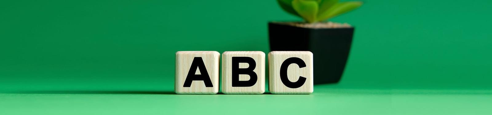 Abfall-ABC Drei Holzwürfel zeigen die Buchstaben A, B und C.